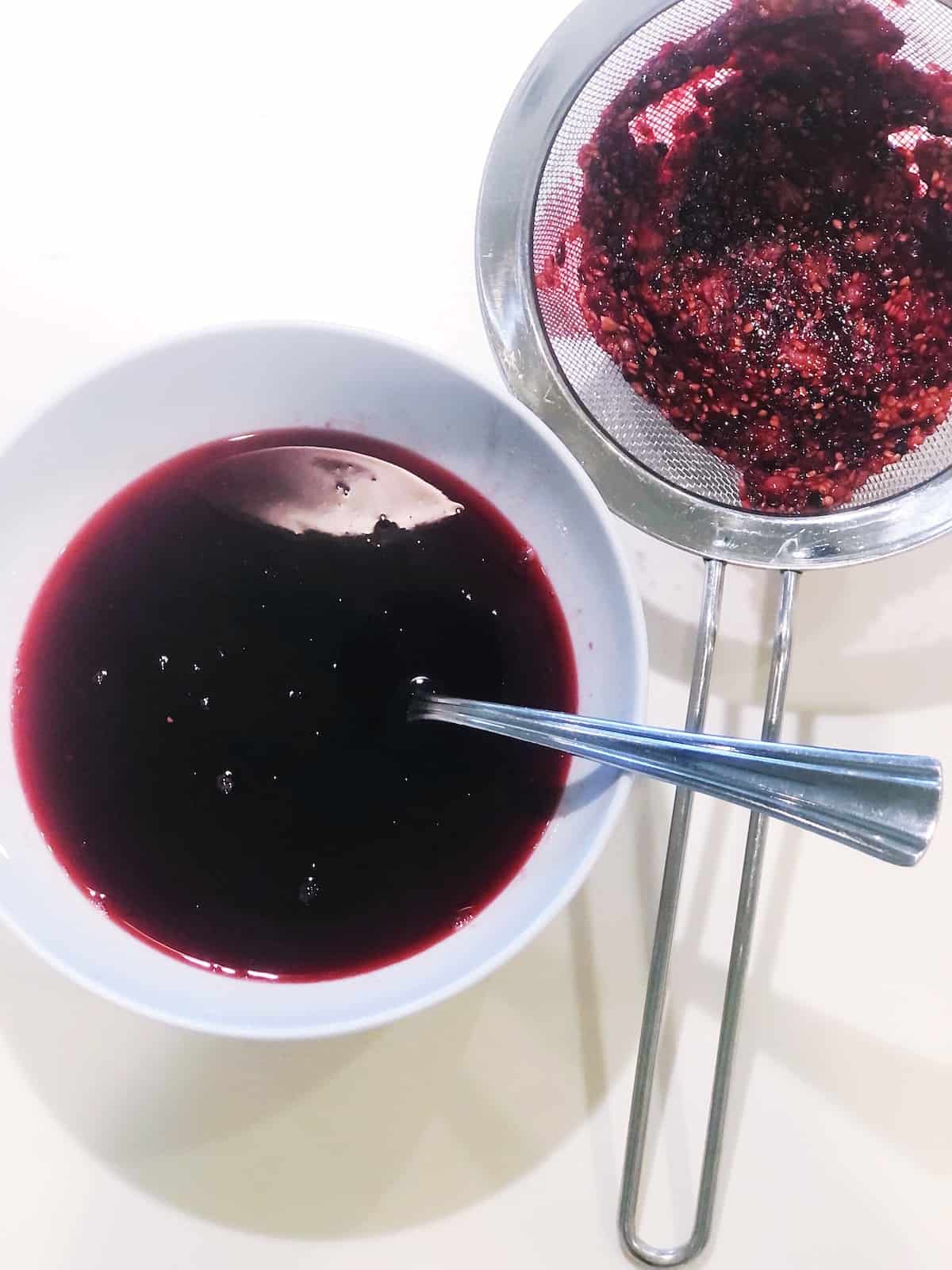 straining blackberry simple syrup