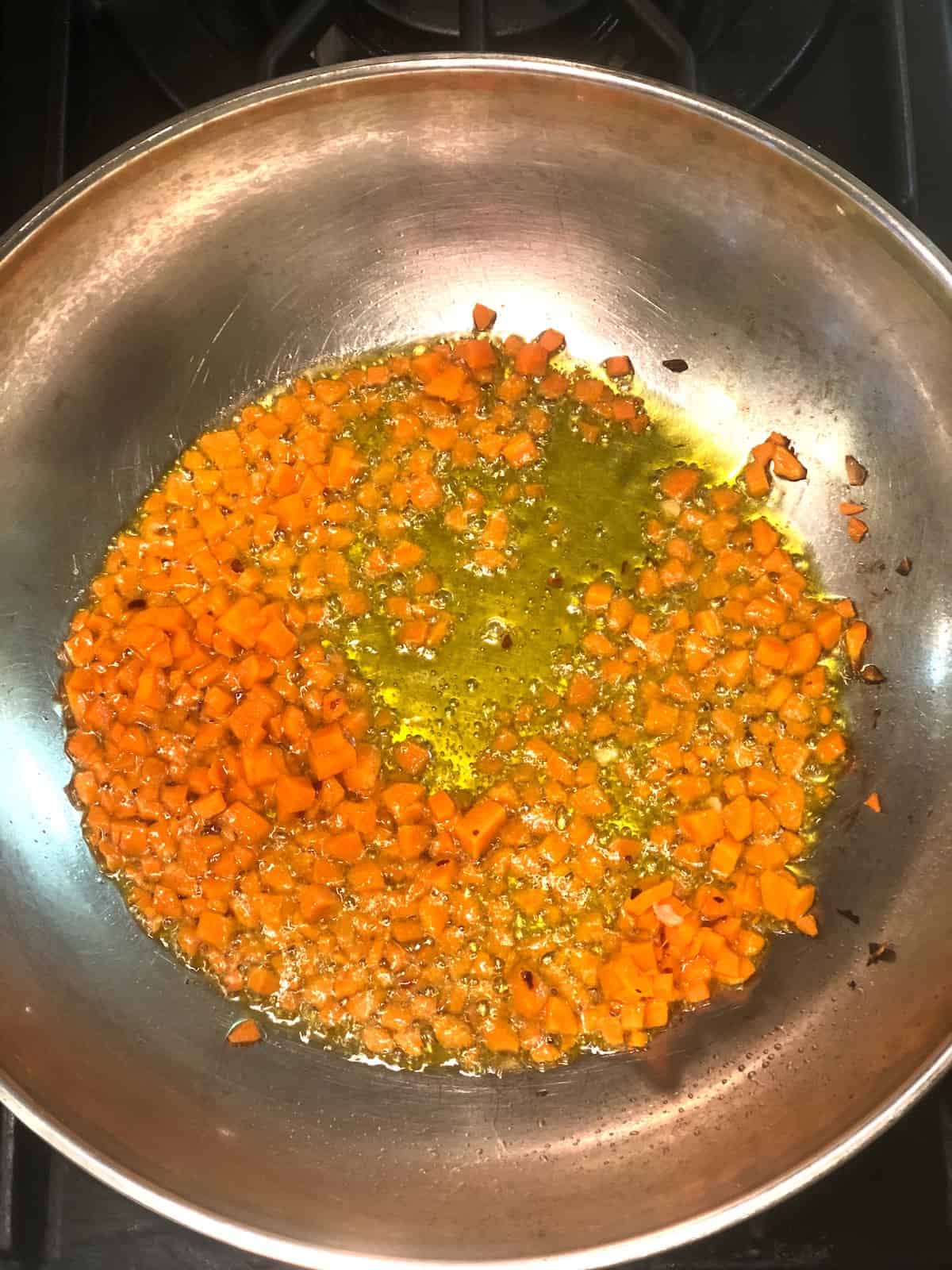 cooking carrots in a pan