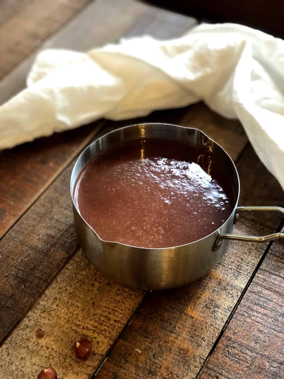 italian hot chocolate drink in pot on a wood board