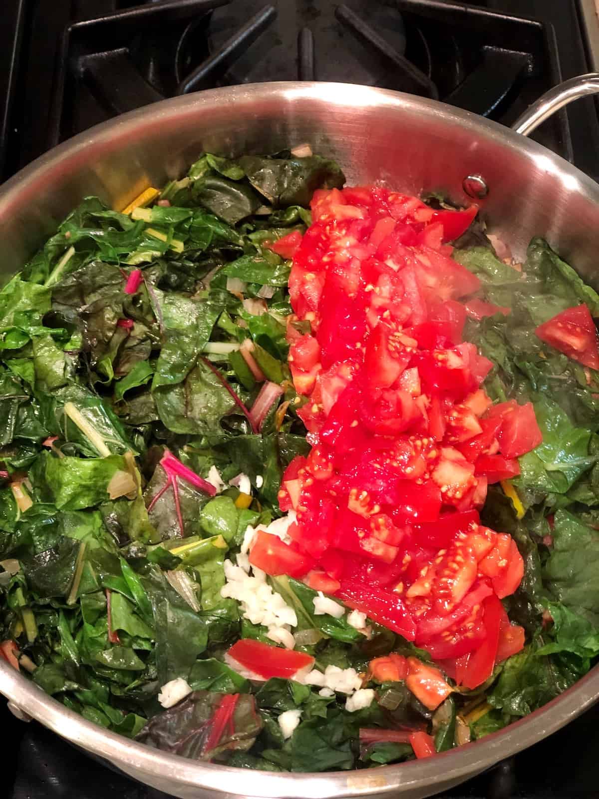 cooking swiss chard with cannellini beans on the stovetop