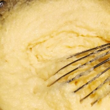 creamy instant polenta in a pot with a whisk