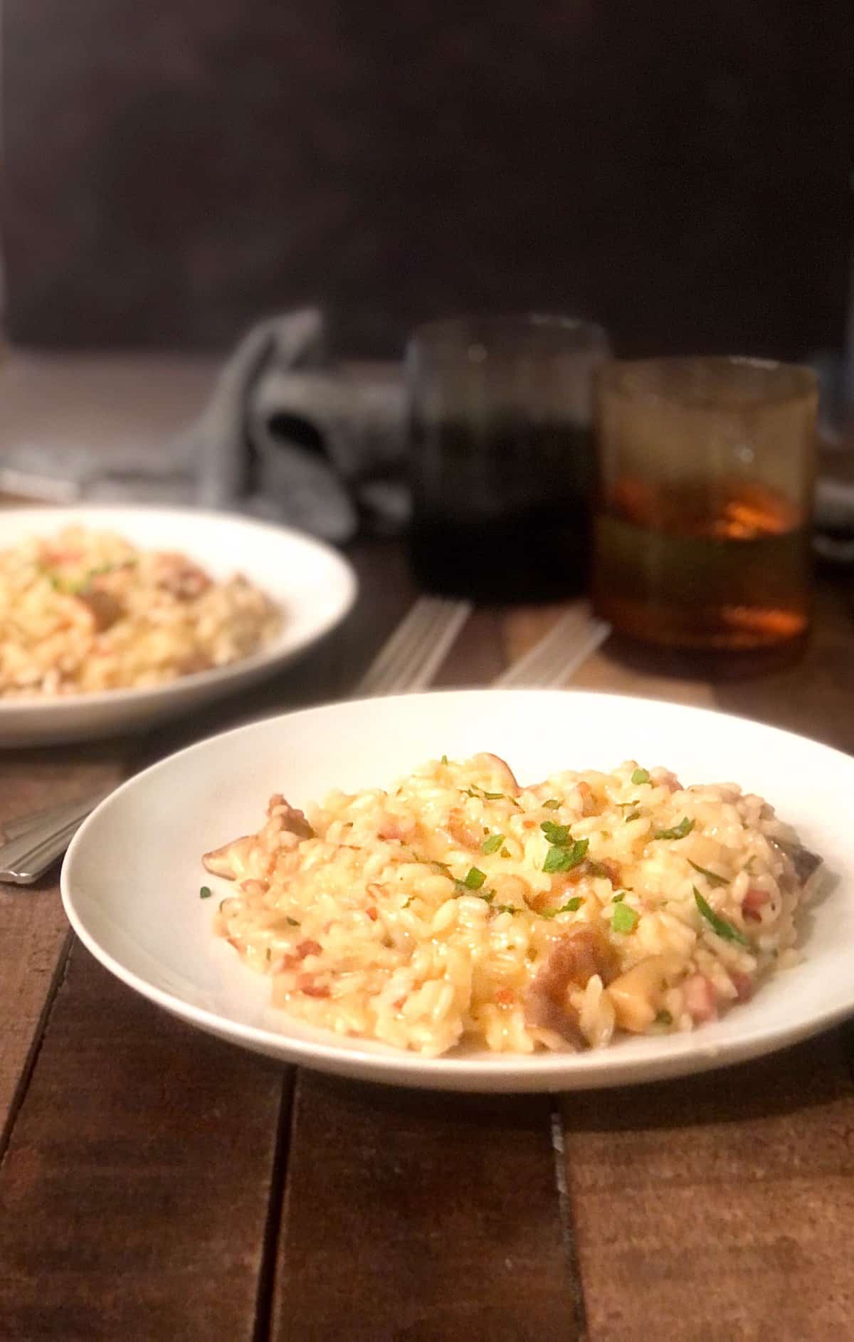 pancetta mushroom risotto in a bowl on wood table