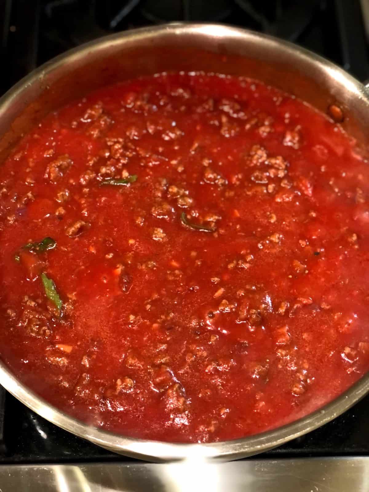 Adding passata to the rigatoni al forno sauce