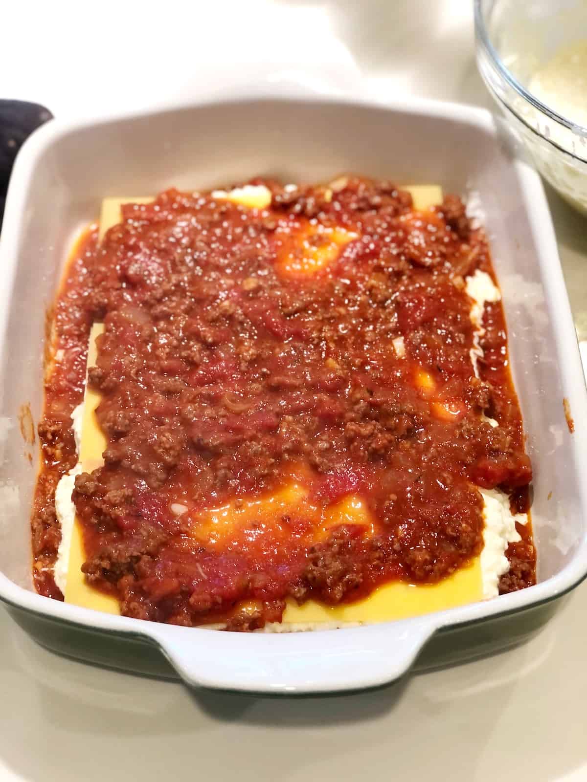 How to make Italian American Lasagna - adding meat sauce layer.