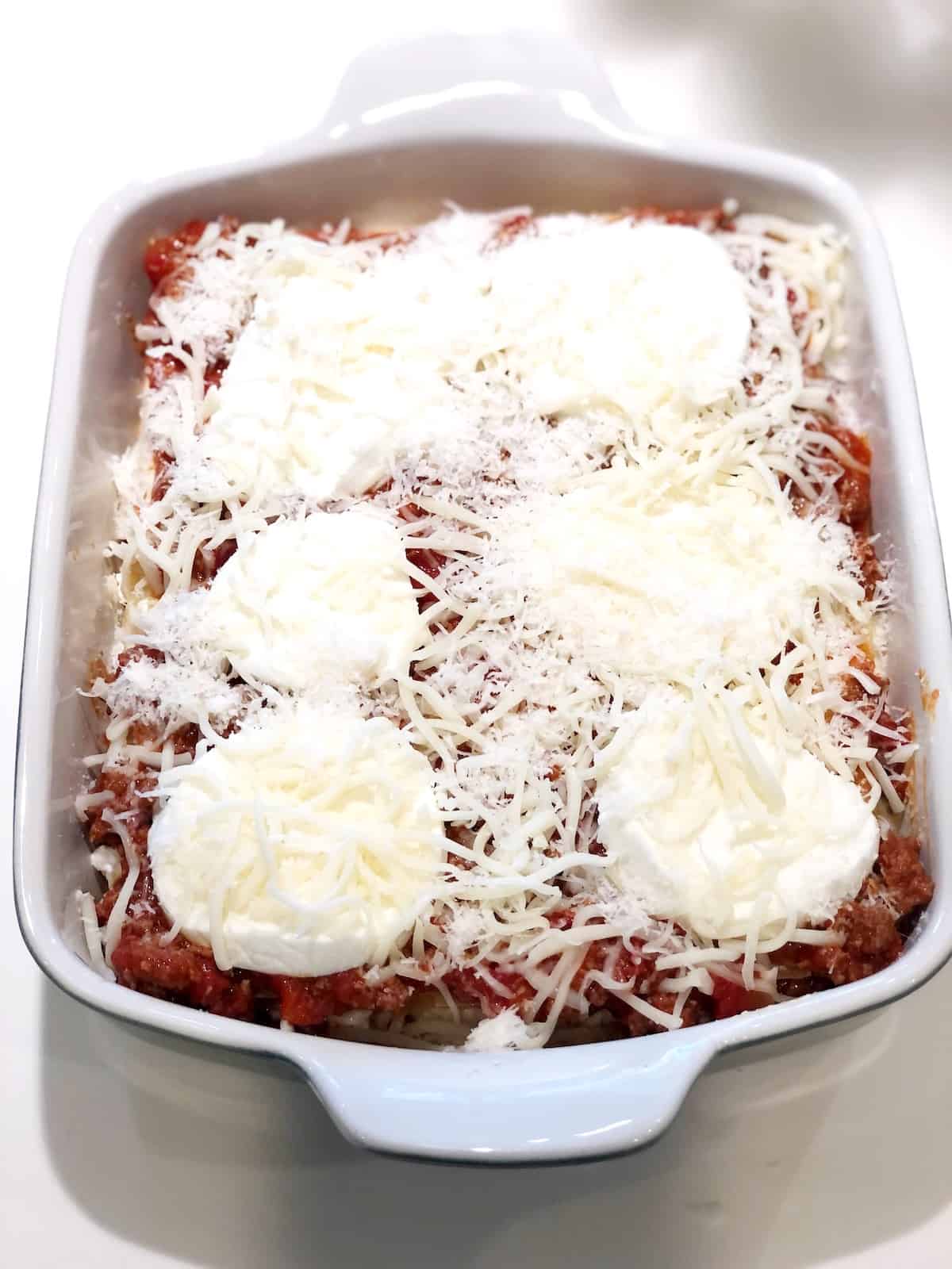 How to make Italian American Lasagna- adding final cheese layer on top before baking.