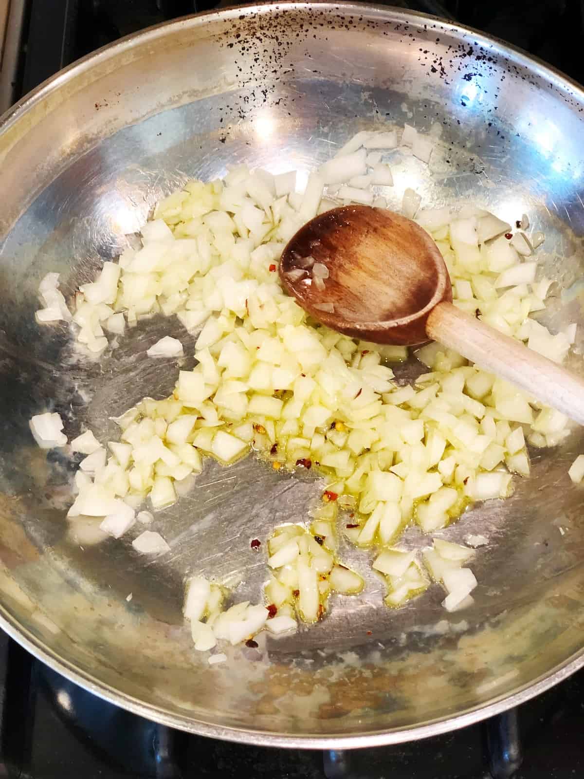 Cooking onions for the tomato sauce for the pork tenderloin in tomato sauce.