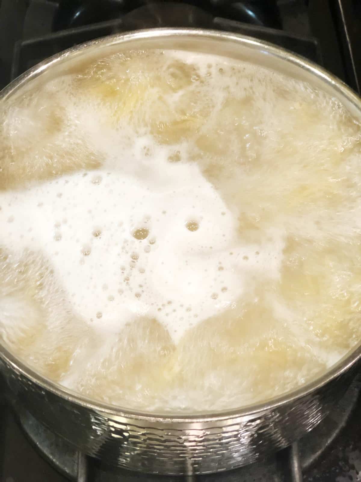 cooking the fettuccine in a large pot.