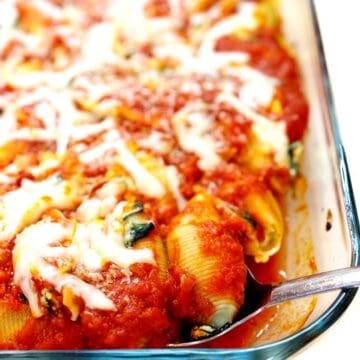 Spinach and cheese stuffed shells in a pan.