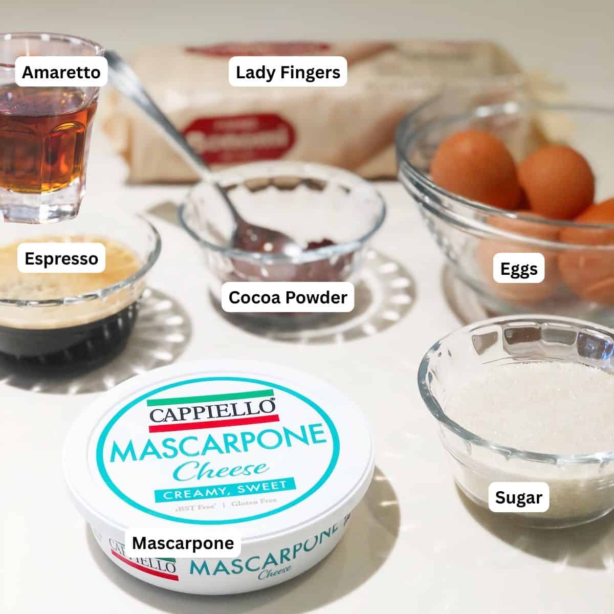 Ingredients for tiramisu with Amaretto on the counter.