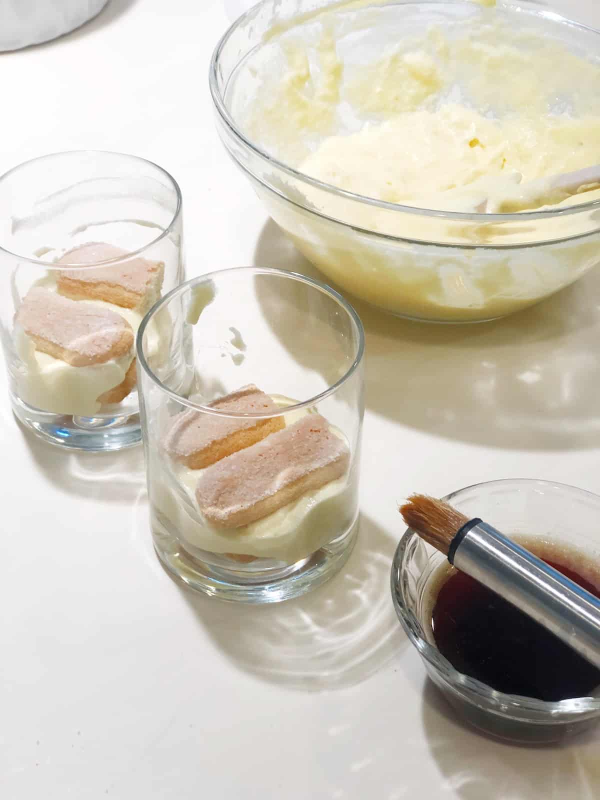 Making Amaretto tiramisu in individual cups.