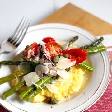 Easy polenta with roasted vegetables in a bowl on the table.