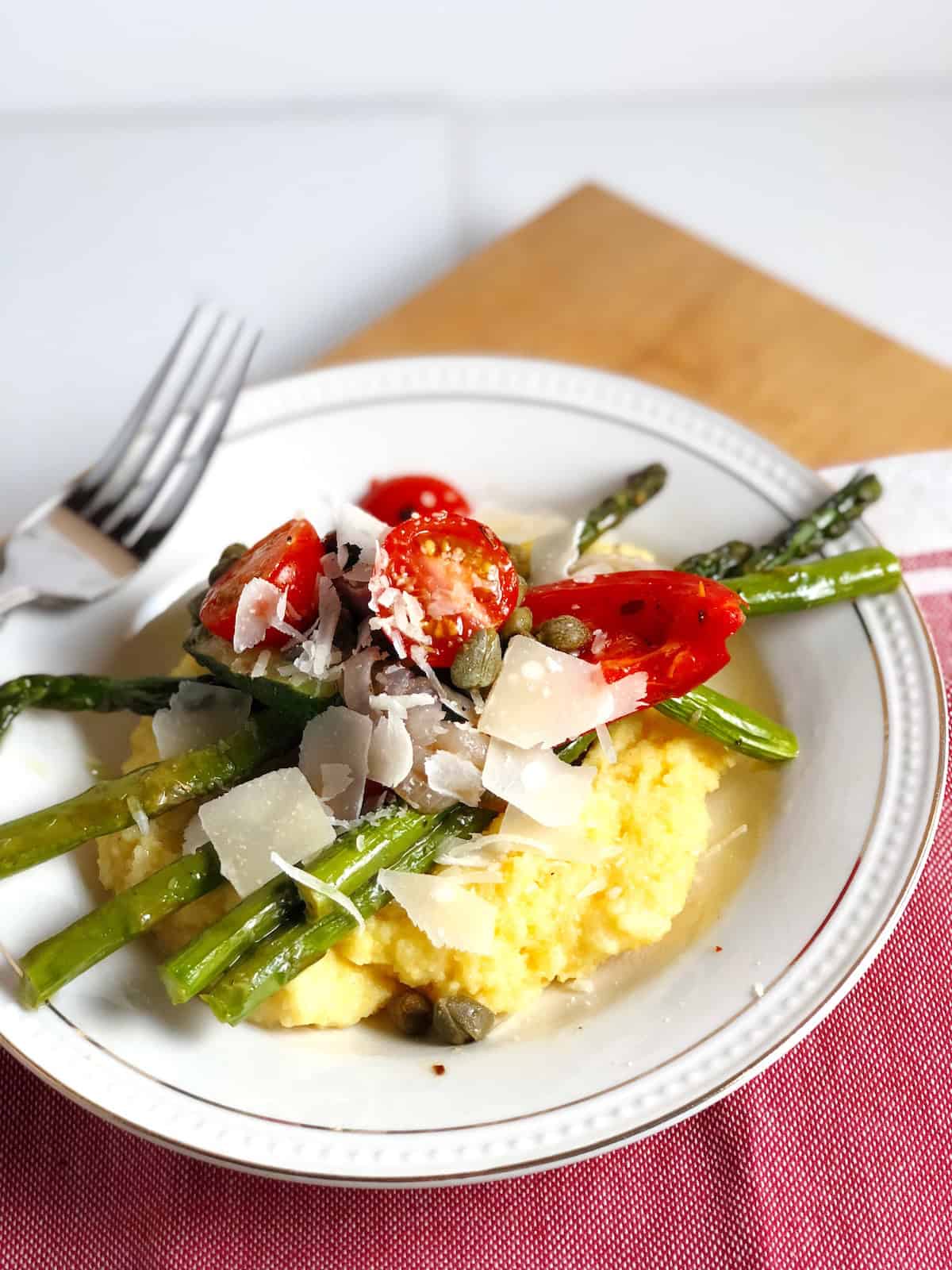 Easy polenta with roasted vegetables in a bowl on the table.