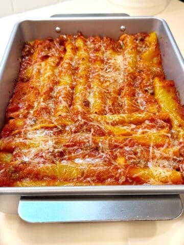 Baked cannelloni with beef in a large baking pan.