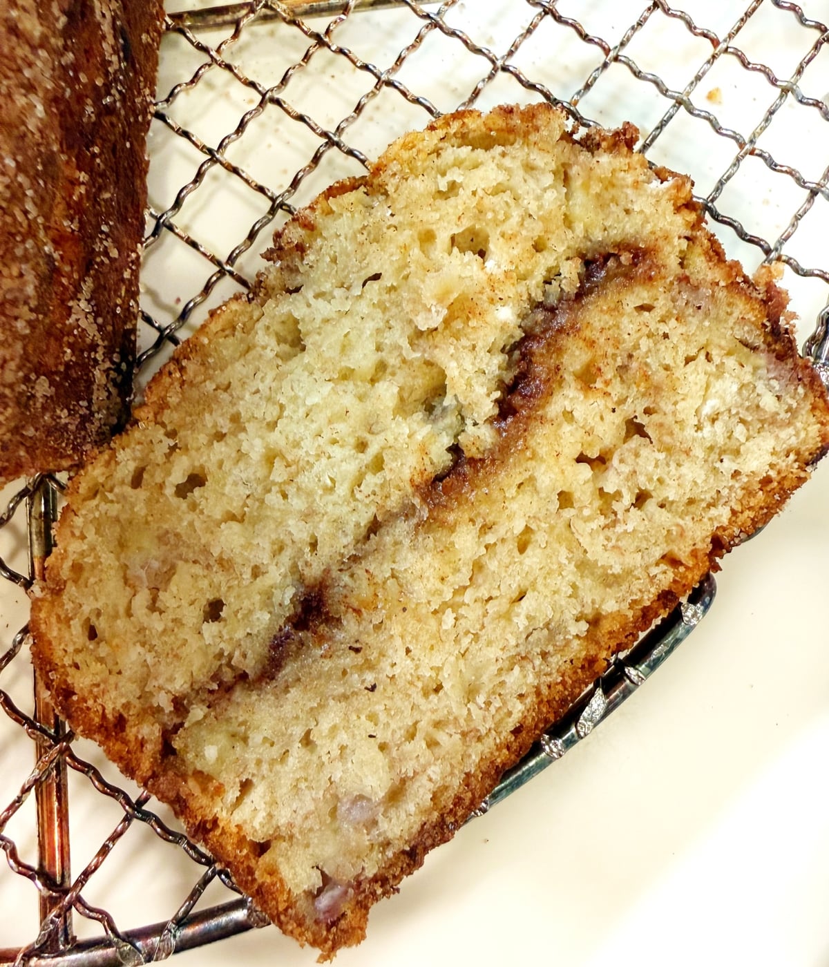 A slice of the banana olive oil bread with a cinnamon sugar swirl in the middle.